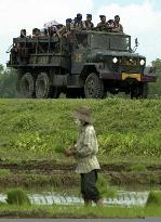 Heavily armed Indonesian police patrol Aceh